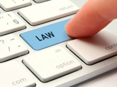 Computer law and justice concept - modernized computer keyboard with law keypad. Computer user searching legal services.