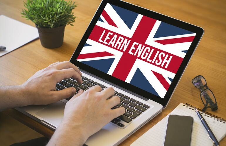 learn english concept. Close-up top view of english learning on laptop. all screen graphics are made up.